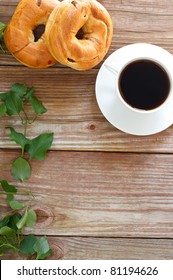 Cup Of Coffee With Bagels On Wooden Table