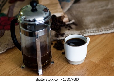 cup of coffee, beans and french press