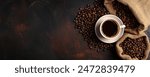 cup of coffee and beans on dark background, top view
