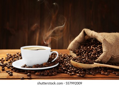 Cup Of Coffee With Beans On Table