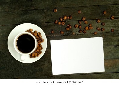 A Cup Of Coffee With Coffee Beans On Wooden Table.Flatlay, Mock Up.