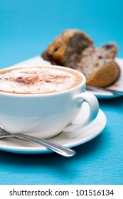 Cup Of Coffee And Blueberry Muffin On Blue Background