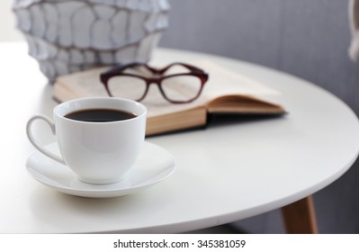 Cup Of Coffee With Book On Table In Room