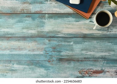 A cup of coffee, books and potted plant on rustic wooden table. Top view with copy space for your advertise text - Shutterstock ID 2254636683