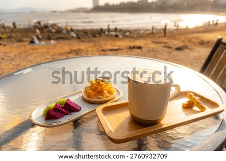 Cup of coffee and a cake on a table of the cafe at the seaside, Qingdao, China.