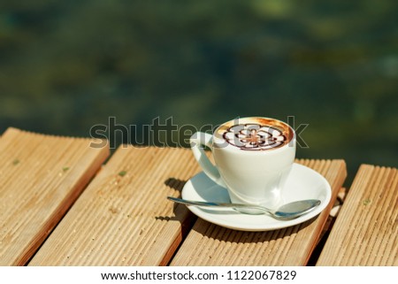 a cup of coffee , cappuccino art , latte art , latte , cappuccino.professional cup of coffee isolated. retro style. wonderful cup of hot drink. Sunny good morning drink. Copy space
