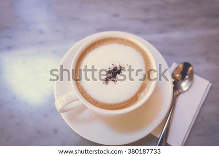 Cup of coffee cappuccino art on wood table/ vintage style