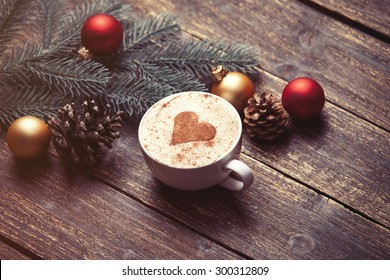 Cup Of Coffee And Christmas Toys On Wooden Table.