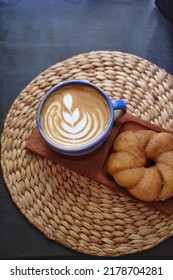 A Cup Of Coffee And A Cinnamon Donut, Top View Selective Focus. Isolated