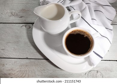 Cup Of Coffee, Creamer On Color Wooden Background