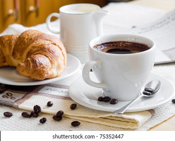 A Cup Of Coffee And Croissant For Breakfast