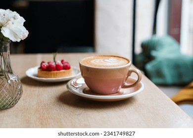 Cup with coffee and dessert on background