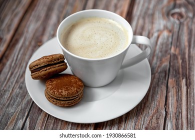 A cup of coffee with dessert on a white plate