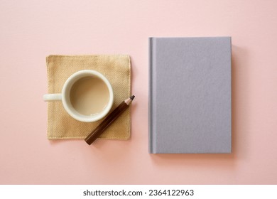 Cup of coffee and diary notebook, colored pencil isolated on pink background. top view, copy space - Powered by Shutterstock