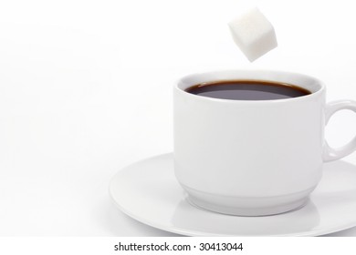 Cup Of Coffee With Falling Sugar Cube