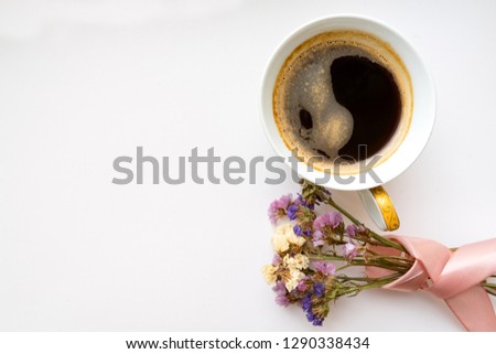 Cup of coffee with flowers and pink ribbon. Flat lay, top view. Valentines and 8 March Mother Women"s Day concept