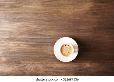 Cup Of Coffee With Foam On Wooden Table, Top View