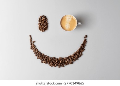 Cup of coffee forms one eye in smiling face made of coffee beans on light background, minimal banner for cheerful cafe branding.