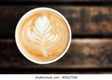 Cup Of Coffee To Go On The Wooden Table With Latte Art. Street Coffee, Top View.