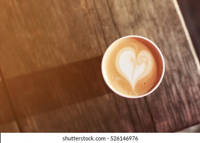 Cup Of Coffee To Go On The Wooden Table With Latte Art. Street Coffee. Top View.