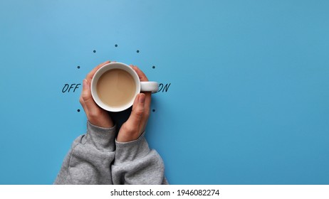 A cup of coffee in hand and a light switch. The symbol of the beginning of the day. Turn on good morning
 - Powered by Shutterstock