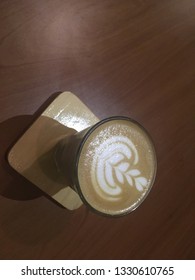 A cup of coffee with heart pattern