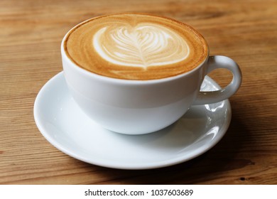 A Cup Of Coffee Latte Art On Wood Table