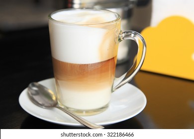Cup coffee latte for cafe menu. Black table, sugar