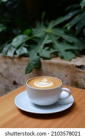 A Cup Of Coffee Latte On White Cup On Wood Table Taken Outdoor 