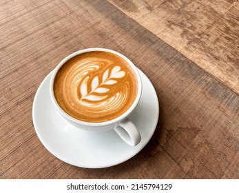 Cup of coffee latte on wood table and beautiful latte art - Shutterstock ID 2145794129
