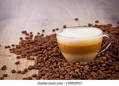Cup of coffee latte on wooden background