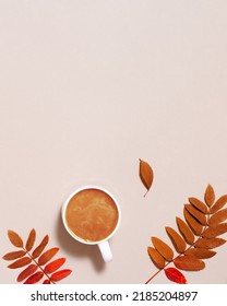 Cup of coffee with milk and red autumn leaves on pastel pink paper background. Autumn, fall composition, monohrome flat lay, top view, copy space. - Shutterstock ID 2185204897