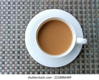 A Cup Of Coffee Mix With Creamer In White Cup For Breakfast. Location At A Hotel In Sukabumi West Java