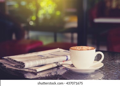 cup of coffee with newspaper in coffee shop.  - Powered by Shutterstock