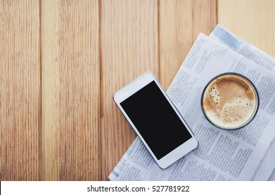 cup of coffee with Newspaper and smartphone in coffee shop.  - Powered by Shutterstock