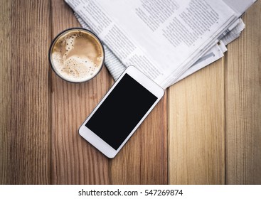 cup of coffee with Newspaper and smartphone in coffee shop.  - Powered by Shutterstock