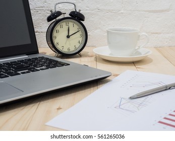 A cup of coffee and notebook on wood table . Coffee break in morning ,break working  / selective focus.Blank seating  indoor in living room .copy space for create idea for business.