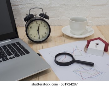 A cup of coffee and notebook on wood table . Coffee break in morning ,break working  / selective focus.Blank seating  indoor in living room .copy space for create idea for business.