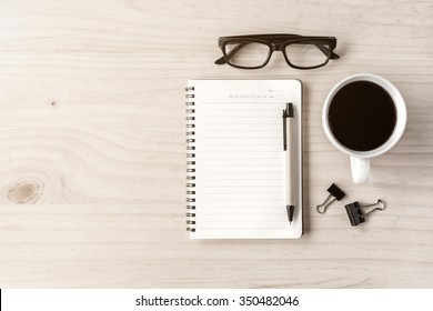 Cup Of Coffee With Notebook On Wooden Desk, Top View, Copy Space