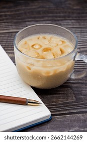 A cup of coffee and a notebook in the study