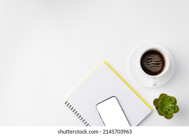 Cup Of Coffee And Notepad On White Background, Top View