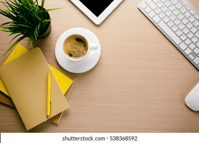 Cup of coffee with office tools on wooden background