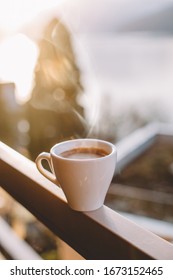 Cup Of Coffee On Balcony In Sunrise On Switzerland Alps