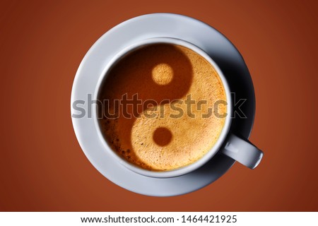 Cup of coffee on black background. Picture of the yin-yang in the coffee crema. top view. coffee in the form of Yin Yang top view