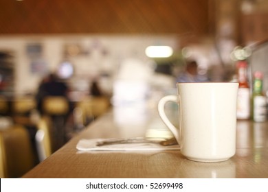 A Cup Of Coffee On The Counter At A Diner.