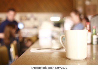 A Cup Of Coffee On The Counter At A Diner.