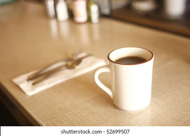 A Cup Of Coffee On The Counter At A Diner.