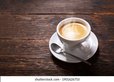 cup of coffee on a rustic wooden table - Powered by Shutterstock