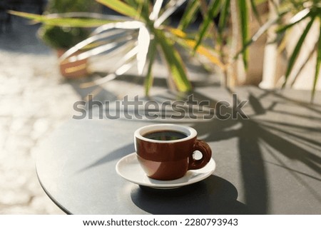 Cup of coffee on a table in a cafe outdoor