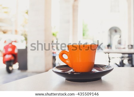 A cup of coffee on table in the cafe outdoors, modern italian style